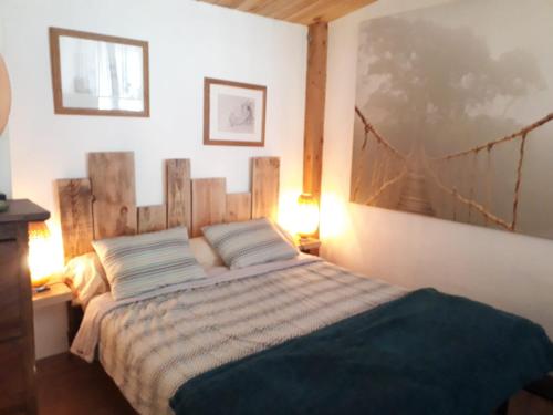 une chambre avec un lit avec une tête de lit en bois dans l'établissement Le chalet, à Roquemaure