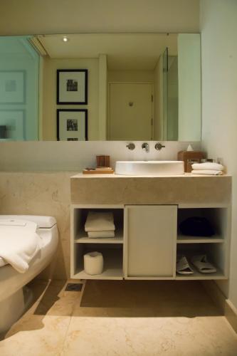 a bathroom with a sink and a mirror at Bali Paragon Resort Hotel in Jimbaran
