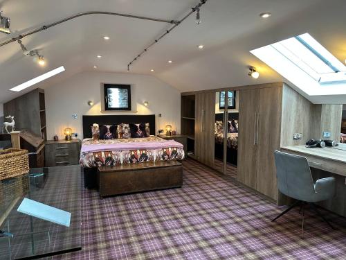 a bedroom with a bed and a desk in a room at Wild boar barn in Bampton