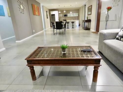 a living room with a chessboard on a coffee table at The Executive - Exclusive Self-Catering Apartments - Ezulwini in Ezulwini
