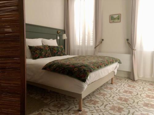 a bedroom with a large bed in a room at Le Couvent des Ecrevisses in Barjols