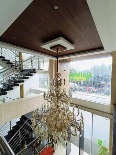 a chandelier hanging from the ceiling in a building at Holiday Residency Coimbatore in Coimbatore