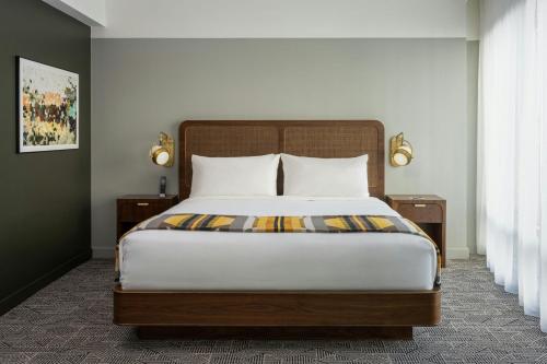 a bedroom with a large bed with two night stands at Asher Adams, Autograph Collection in Salt Lake City