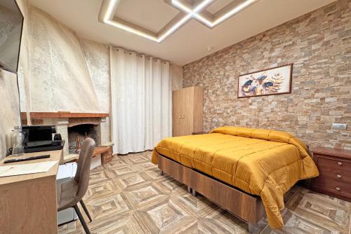 a bedroom with a bed and a desk and a television at Red Rose Exclusive Rooms in San Cesareo