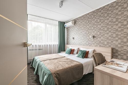 Postel nebo postele na pokoji v ubytování Hotel Zemaites