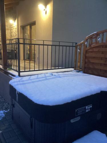 a mattress sitting on a balcony with snow on it at Apartmány Ořechovka Wellness in Turnov