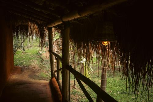 a room with a grass roof with a light at The Soul Marayoor Mudhouse - Munnar in Marayoor