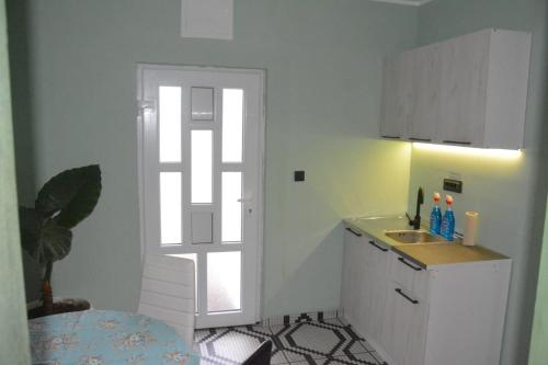 a small kitchen with a sink and a window at Gazdinstvo Tadić in Nikšić