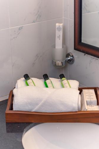 a couple of towels on a wooden tray in a bathroom at Ivory Resort Dikwella in Dickwella