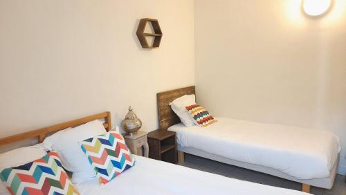 a small room with two beds and a bedskirts at La Mansarde in Saint-Émilion