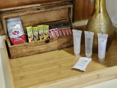 a wooden box with four vases on a table at The Executive - Exclusive Self-Catering Apartments - Ezulwini in Ezulwini
