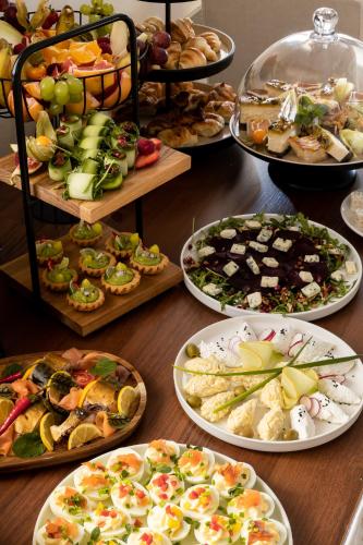 a table with many plates of food on it at Coco Boutique Hotel & Spa in Karpacz