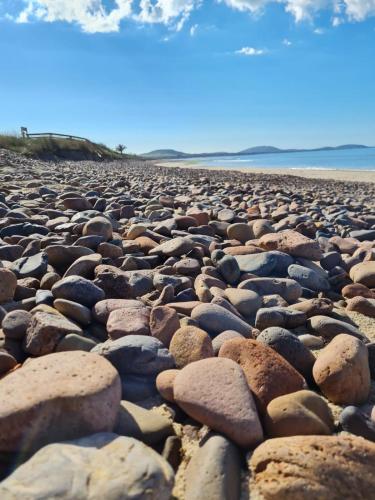 a large group of rocks on a beach at Cabañas de Bella Vista in Bella Vista