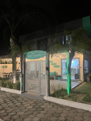 a palm tree in front of a building at night at Dona Catarina Hotel in Florianópolis