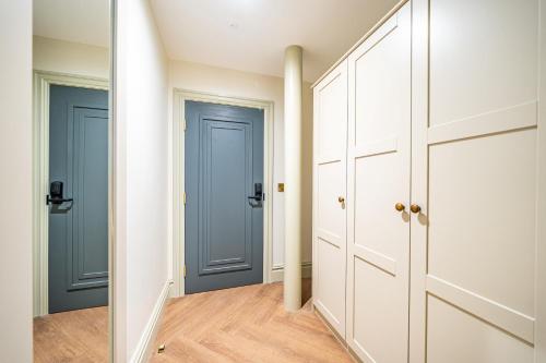 two doors in a hallway with wood floors at St Marys Quarters in Nottingham