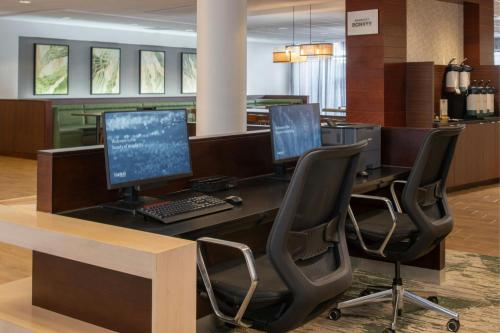 an office with two computer monitors on a desk at Fairfield Inn & Suites by Marriott Tampa Westshore/Airport in Tampa