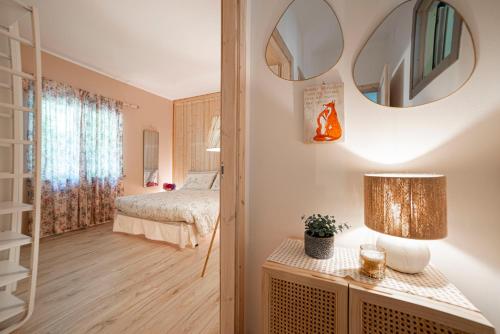 a bedroom with a bed and a mirror on the wall at B&B Botton d'Oro Valle Imagna in Fuipiano Valle Imagna
