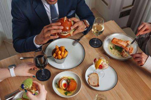 a group of people sitting at a table eating food at Radisson Blu Hotel, London Bond Street in London