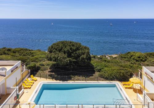 a swimming pool with a view of the ocean at 30 Terracos de Benagil - Casa Domingos in Benagil
