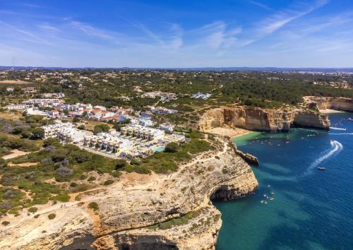 an aerial view of a village on a cliff over the ocean at 30 Terracos de Benagil - Casa Domingos in Benagil