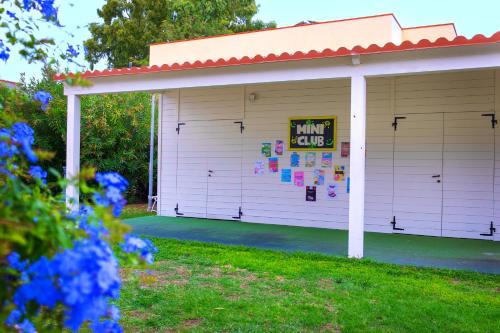 a garage with a sign on the side of it at Cala Della Torre Resort in La Caletta