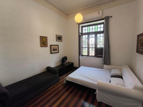 a bedroom with a bed and a window at Guattari House Santa Teresa in Rio de Janeiro