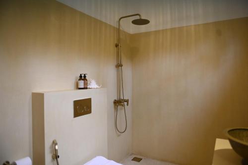 a shower in a bathroom with a white refrigerator at Mayava Villa in Ahangama