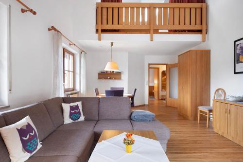 a living room with a couch and a table at Haus an der Gutach in Titisee-Neustadt