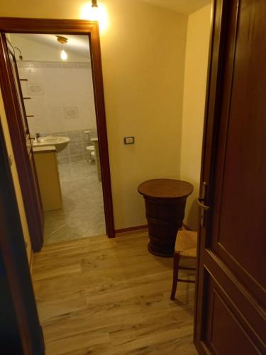 a room with a bathroom with a sink and a table at La sosta di Fano in Reggello