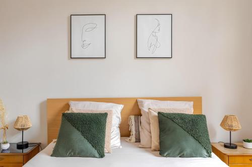a bedroom with a bed with two pictures on the wall at Nancy Gare Centre Parking in Nancy