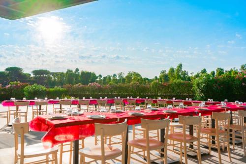 a group of tables and chairs with red tablecloths at Camping Village Roma Capitol in Ostia Antica