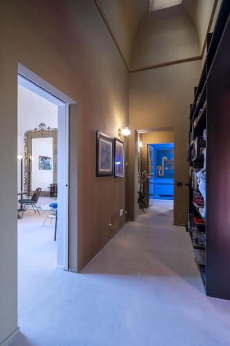 a hallway with a door leading to a living room at Fiermonte Museum by La Fiermontina in Lecce