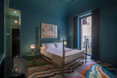 a bedroom with a bed in a blue room at Fiermonte Museum by La Fiermontina in Lecce