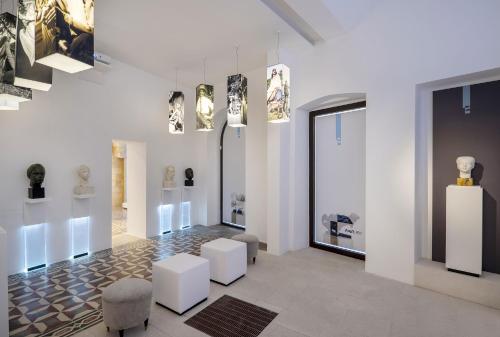 a museum with a bunch of art on the walls at Fiermonte Museum by La Fiermontina in Lecce