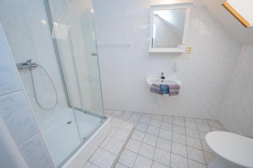 a bathroom with a shower and a sink at Penzion Zuzana in Staré Splavy