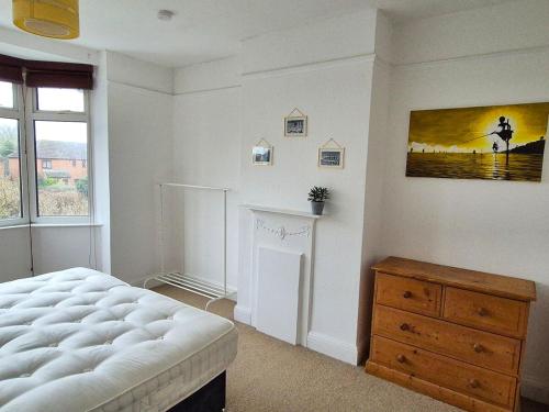 a bedroom with a bed and a window and a dresser at Spacious Flat Near Train Station - By ShireStays in Bicester