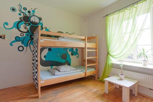 a bedroom with two bunk beds in a room at Pogo Hostel in Vilnius