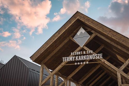 a building with a roof with a sign on it at Termy Karkonosze Resort & Spa koło Karpacza in Staniszów