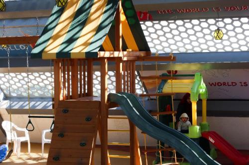 a bunk bed with a slide in a play room at Steigenberger Hotel Doha in Doha