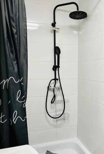 a shower with a shower head in a bathroom at Noclegi Mosina - Business & Workers in Mosina