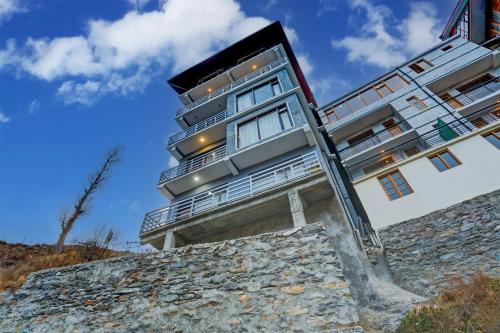 a building on top of a stone wall at Utpala House By Lifestyle Stays in Sissu