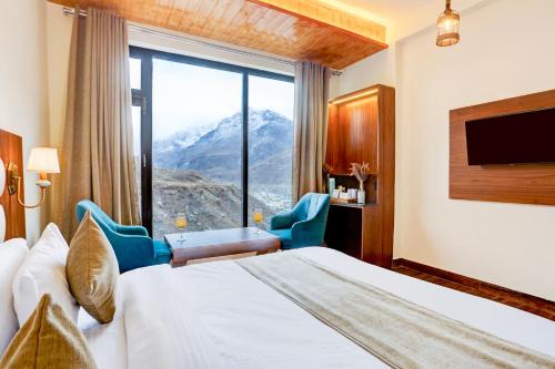 a hotel room with a bed and a large window at Utpala House By Lifestyle Stays in Sissu