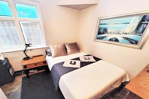 a small room with two beds and a table at Sea Point Lifestyle Lodge in Cape Town