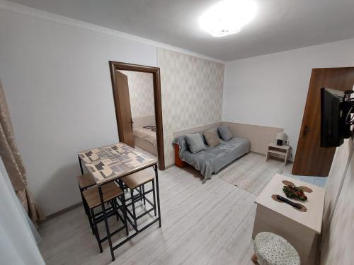 a living room with a couch and a table at New Edenia Apartment in Craiova