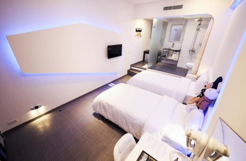 a hospital room with a bed and a mirror at Galaxia Business Hotel in Taichung