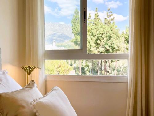 a bedroom window with a view of a mountain at Luxury Duplex Penthouse Sea Views in Marbella Golden Mile in Marbella