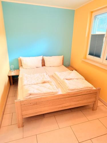 a bedroom with a wooden bed in a room at Natur und Meer in Graal-Müritz