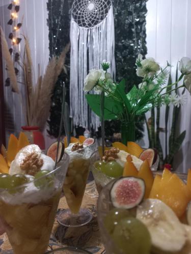 a table topped with different types of fruits and drinks at Hostal Sisabel in Tinogasta