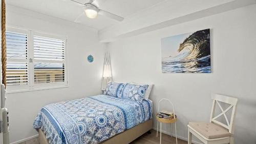 Ένα ή περισσότερα κρεβάτια σε δωμάτιο στο Ocean Waves