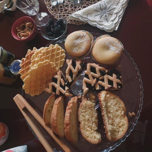 a table topped with a plate of pastries and waffles at La casa di Zia Mimina in Civitella Casanova